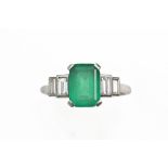 An Art Deco emerald and diamond ring, centred with an emerald-cut emerald approx. 1.
