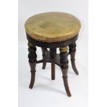 A late Regency faux rosewood brass mounted piano stool,