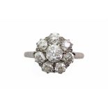 An early/mid 20th century old-cut diamond eight stone cluster ring, the central stone approx. 0.