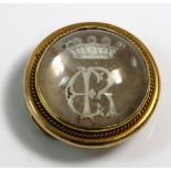 An early 20th century gold and reverse crystal intaglio slide/button,