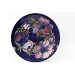 A William Moorcroft 'Anemone' pattern plate, signed in green 'WM' to base and impressed 'Moorcroft,