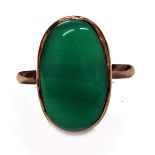 A green chalcedony single stone ring, the oval cabochon rub-over set in yellow metal, stamped '14K',