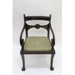 A Regency ebonised gilded and gilt metal mounted open arm elbow chair,