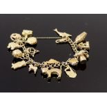 A 9ct gold curb link 'charm' bracelet hung with 17 various charms including a kangaroo and