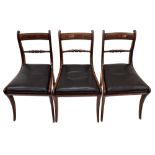 A set of six Regency rosewood brass strung and crossbanded dining chairs, with curved top rails,