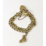 An 18ct gold curb link bracelet of two row design, hung with two charms, on a padlock clasp,