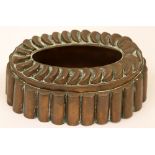 A Victorian copper oval shaped jelly mould, crown of overlapping discs and fluted sides, unmarked,