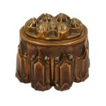 A late Victorian copper oval shaped jelly mould, six fluted pointed bosses,
