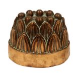 A 19th century copper oval shaped jelly mould, with eight domed flutes and two rows of stiff leaves,