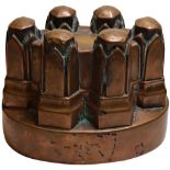 A Victorian oval copper jelly mould, no. 46, with six moulded hexagonal turrets, stamped '46', 12.