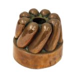 A Victorian copper circular shaped jelly mould, with eight slanting shaped flutes,