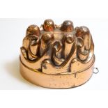 A Victorian oval copper jelly mould by Benham & Froud, no. 626, with six domes and spirals, 11.
