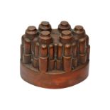 A Victorian oval copper jelly mould, no. 617, of six fluted turrets, engraved initials T.M.