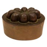 An early Victorian copper oval shaped jelly mould, with raised eight-lobed rosette,