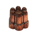 A Victorian copper circular shape jelly mould with six, wavy top turrets, on pointed panel base,