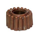 A Victorian copper ring shaped jelly mould, with eighteen tapered flutes, around a raised centre,
