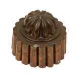 A Victorian copper circular shaped jelly mould, domed, lemon squeezer top, on flared fluted base,