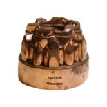 A 19th century French copper circular tiered jelly mould, by Trottier, ribbon scrolled top,