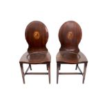 A pair of George III mahogany hall chairs,