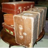 Two early 20th century brown leather travelling cases and two canvas travelling trunks, (4).