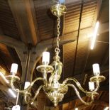 A pair of 20th century six branch brass chandeliers.