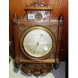 An early 20th century oak mounted barometer,