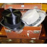 A group of vintage hats and clothing, including two felt top hats, a lambskin hat,