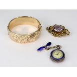 A Victorian gold and oval amethyst single stone brooch with an open scroll frame;