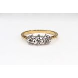 A modern diamond three stone ring, the slightly graduated round brilliants approx. 0.