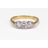 An 18ct gold and diamond three stone ring, the slightly graduated round brilliants approx. 1.