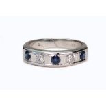 A modern 18ct white gold, sapphire and diamond five stone half-eternity ring,