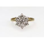 A modern 18ct gold and diamond seven stone cluster ring, the round brilliants approx. 1.