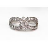 A modern diamond ring in the form of an open figure of eight,