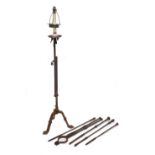 Four various 19th century steel fire pokers and a large pair of fire tongs and a wrought metal