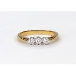 A diamond three stone ring, the round brilliants approx. 0.