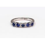 A modern 18ct white gold, sapphire and diamond half-hoop ring,