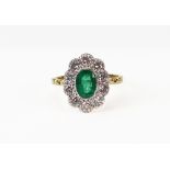 A modern emerald and diamond oval cluster ring,