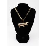 A 9ct gold and cubic zirconia articulated 'hippopotamus' pendant, on a 9ct gold filed-curb necklace,