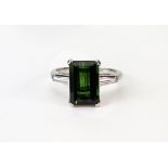 A green tourmaline and diamond three stone ring,