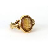 A Victorian gold and yellow paste oval signet ring with a lion rampant crest,