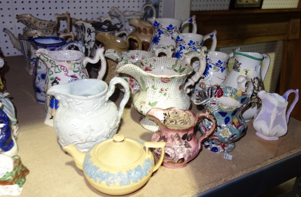 A quantity of Victorian ceramic jugs of varying shapes and makes and a blue and yellow Wedgwood