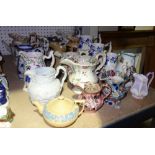 A quantity of Victorian ceramic jugs of varying shapes and makes and a blue and yellow Wedgwood