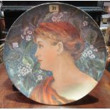 A 20th century ceramic plate painted with a female portrait,