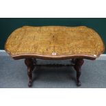 A Victorian marquetry inlaid figured walnut shaped centre table on carved and fluted columns and