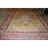 A Kerman carpet, Persian, the sage field with a bold indigo rosette, matching spandrels,