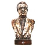 A patinated plaster bust, late 20th century, depicting a middle aged gentleman in a blazer,