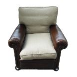 A mid 20th century French brass studded brown leather upholstered easy armchair on bun feet,