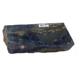 A lapis type hardstone specimen, with further coloured hardstone inclusions, 35cm wide.