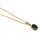 An 18ct gold, sapphire and diamond set oval cluster pendant, claw set with the oval cut sapphire,