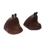 A pair of hardwood and steel bound enclosed stirrups, early 20th century, possibly South American,